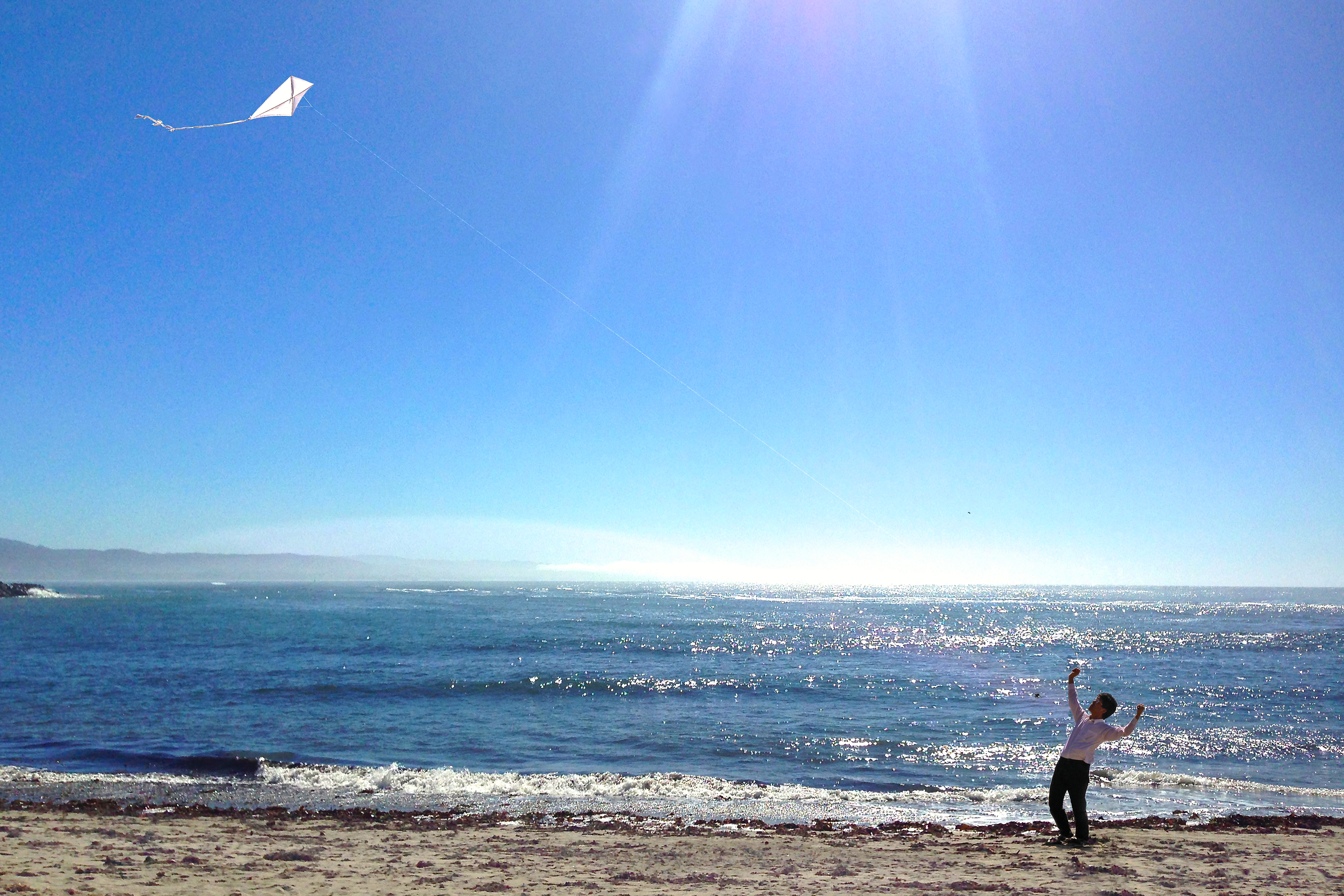 Tadashi at Halfmoon Bay flying a kite